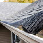 Roll,Of,Plastic,Mesh,Guard,Over,Gutter,On,A,Roof